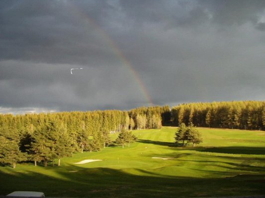 Vue d'un arc en ciel sur Gap-Bayard